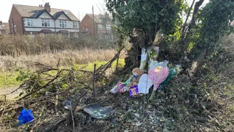 Asha Patel/BBC A teddy bear and flowers were spotted off Radcliffe Road in West Bridgford