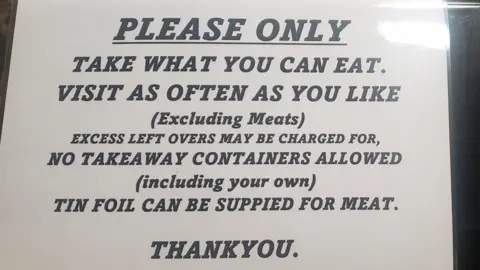 The Star Inn Sign at The Star Inn at Vogue in St Day. It says: "Please only take what you can eat. Visit as often as you like (excluding meats). Excess left overs may be charged for, no takeaway containers allowed (including your own) tin foil can be supplied for meat. Thank you."