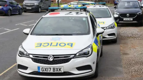Two police cars parked on Gossops Drive in Crawley