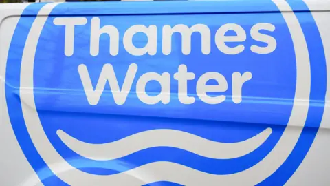 The side of a Thames Water van showing the company's blue ad white logo