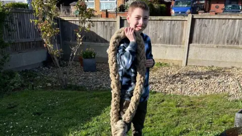 Picture supplied Theo stands with a large piece of rope over his shoulder