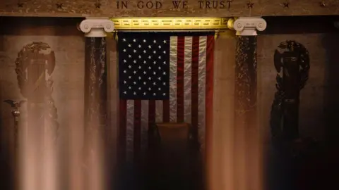 File image inside the US Capitol with an inscription on the wall that reads: "In God we trust"