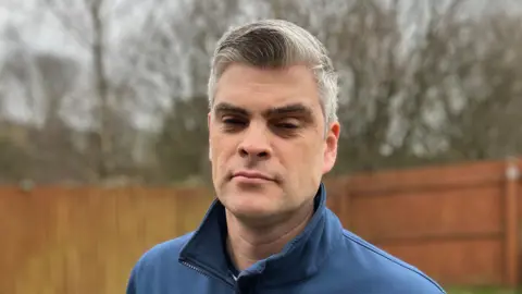 BBC Heywood resident Chris Brierley in his garden