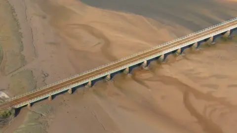 An aerial view of Eskmeals viaduct across the coastline.