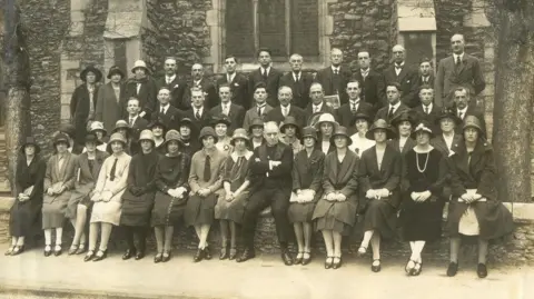 A black and white photo of a large group of people outside a church taken in 1926.