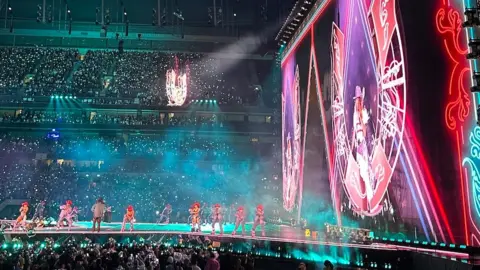 Dancers line the stage at the Tottenham Hotspur Stadium