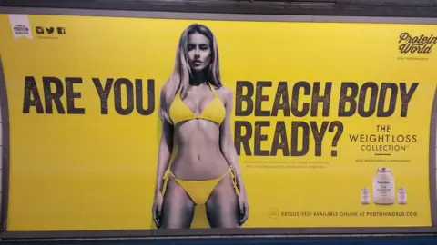 PA Media A Protein World advert displayed in an underground station in London