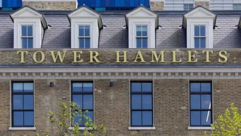 Getty Images Tower Hamlets sign on Tower Hamlets Town Hall in London.