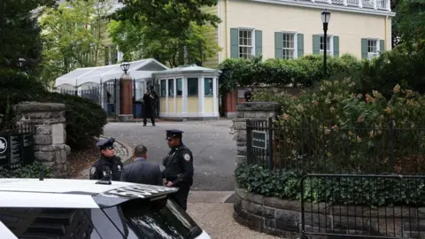 Getty Images | NYPD officers patrol Gracie Mansion, the Mayor's residence, on 26 September in New York City