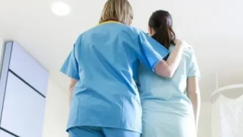 Science Photo Library Nurse and woman