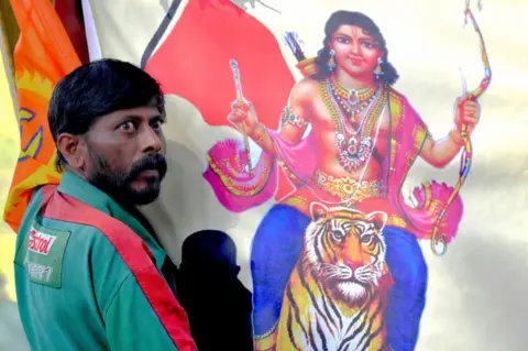 Getty Images An Indian Hindu devotee of the Lord Ayyappa looks on at a protest in Kerala.