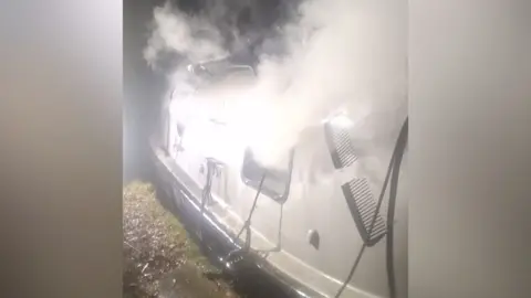 Smoke coming out of a canal boat.