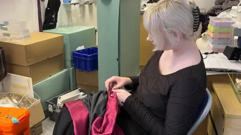 Cumberland Council A volunteer working on a fabric loaned for the exhibition