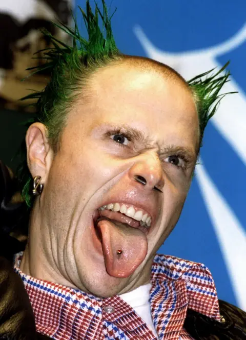 Reuters The Prodigy lead singer Keith Flint sticks out his tongue at press photographers during the 1996 MTV Europe Music Awards gala in London