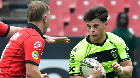 Ewan Rosser of Dragons RFC takes on Morne van den Berg of Emirates Lions