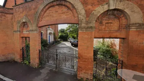 Somerset Council Image shows the same area in the picture above but from a point further back, which shows a red brick archway. 