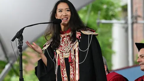 Getty Images Yurong "Luanna" Jiang, dressed in black rope and colourful traditional Chinese clothing, delivers the Graduate English Address during commencement exercises at Harvard University