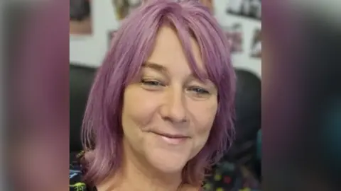 The Ark Trust A profile photo of Andrea McCombie, CEO of Ark Trust. She has dyed purple hair and appears to be in her 40s