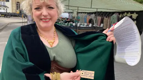 A brown tag which says 'Betty Boothroyd.'