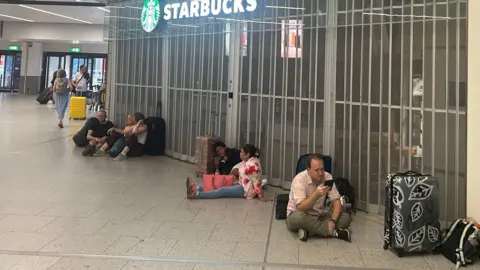 PA Media Gatwick shops closed amid a water outage 