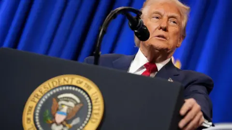 Donald Trump pictured behind the podium during a press conference 