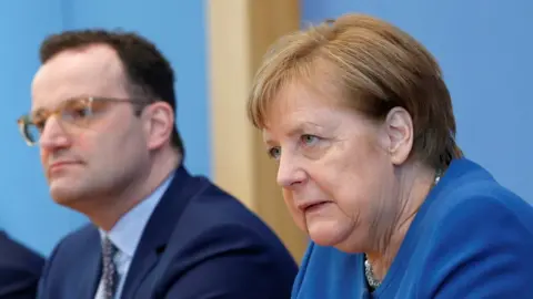 Reuters Chancellor Merkel addressed reporters alongside health minister Jens Spahn