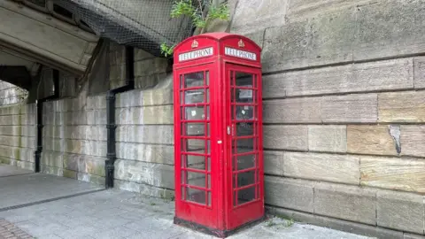 Phone box under Under Friar Gate Bridge in Derby