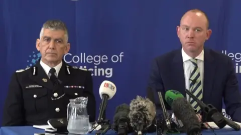 PA Media Andy Marsh, chief executive of the College of Policing, left, and police and crime commissioner for Lancashire Andrew Snowden at a press conference in Preston earlier