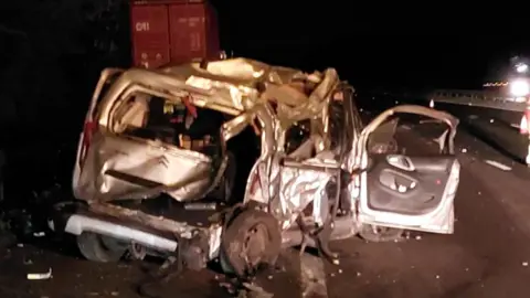 Thames Valley Police A crushed van on the hard shoulder of the motorway