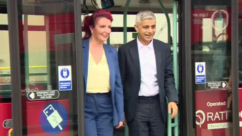 Transport Secretary Louise Haigh and Mayor Sadiq Khan smiling as they step off a bus