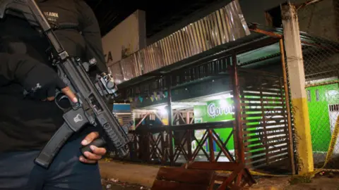 AFP / Getty Images A police officer guards a bar and liquor store where an armed attack against civilians took place in El Empalme, Ecuador, on July 28, 2025.