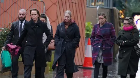 PA Media Brianna Ghey's mother Esther Ghey (third right) and sister Alisha Ghey (second right) arriving at Manchester Crown Court,