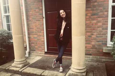 Mona stood at the front door of her dad's house