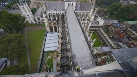 PA Media An aerial view of the team abseiling down the West Towers