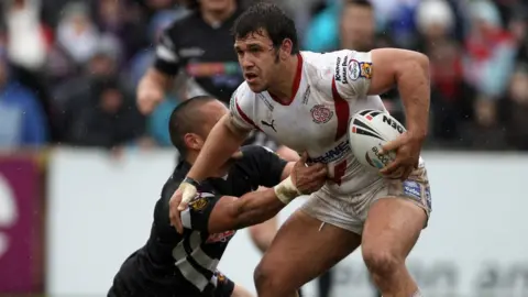 Getty Images Scott Moore of St. Helens is tackled by Thomas Leuluai of Wigan Warriors during the Engage Super League match in 2010