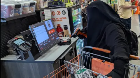 The woman in a black niqab with a shopping trolley seen buying bomb-making parts at a local hardware store