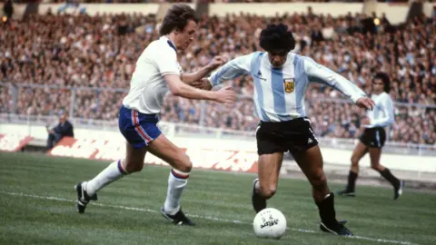 Getty Images England's Phil Neal challenges Argentina's Diego Maradona for possession of the ball