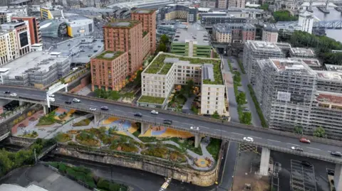 5plus Architects/blocwork/Platform 4 A CGI showing an aerial view of the proposed development. Two large apartment buildings have been built behind the Redheugh Bridge. A park made of green spaces and grey paths has bee built underneath the bridge. A large car park has also been built to the back of the development.