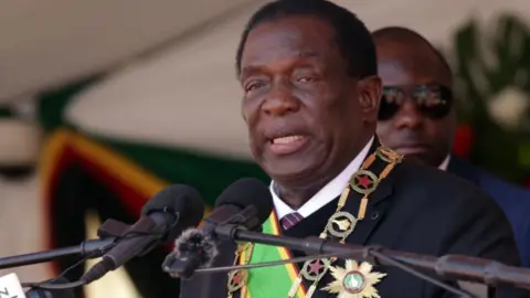 EPA Zimbabwean President Emmerson Mnangagwa delivers a speech at Defence Forces Day celebrations at the National Sports Stadium in Harare, Zimbabwe, 15 August 2023