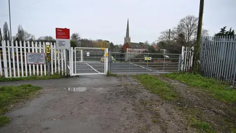 Rail Accident Investigation Branch A gated level crossing with a police car parked nearby