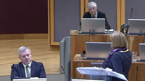 Jeremy Miles sat next to Lynne Neagle as she responds to Mark Drakeford in the Senedd