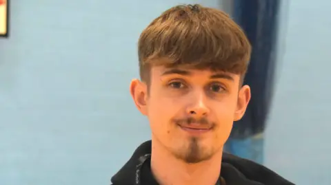 Suffolk New College A head and shoulders image of Daniel. He is smiling and looking into the camera.