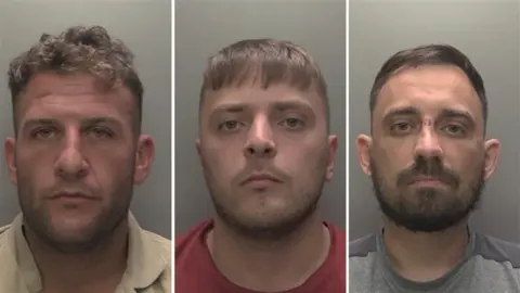 Humberside Police A composite of three side-by-side mugshots of men set against a grey background. Each man has short hair and facial hair. They are looking directly at the camera. The man on the left, Lee Jenkinson, is wearing a cream shirt. The man in the middle, Liam Langton, is wearing a red t-shirt and the man on the right, Luke Gilson, is wearing a grey t-shirt. 