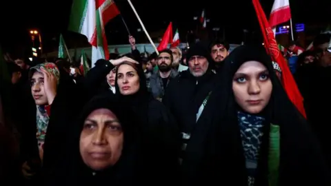 People in Iran gather after a two week ceasefire was announced