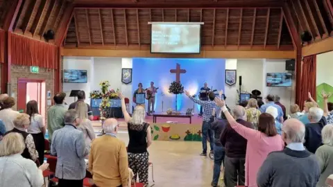 David Sims David Sims congregation worshipping at church