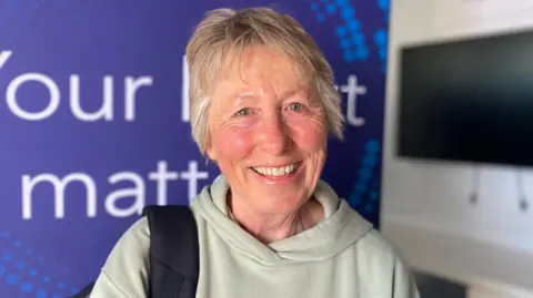 Josephine Feeney inside the Your Heart Matters truck looking at the camera

