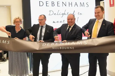 Getty Images Staff cut a ribbon at an Debenham's store