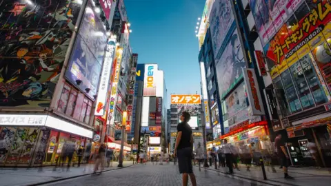 Getty Images Young man at Akihabara electric town, street view, Tokyo, Japan.