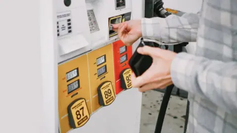 Getty Images Stock image of a man paying for petrol at a fuel pump