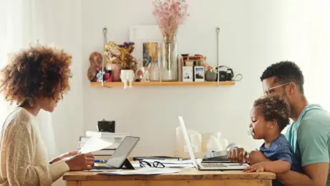 Getty Images A young family working from home